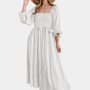 Black puff sleeve midi dress with a tie waist, designed for a casual yet elegant spring look, shown in size 2XL.