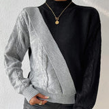 Black ribbed knit turtleneck sweater featuring chunky white contrast sleeves, showcasing a stylish design with focus on the neck and shoulder areas.