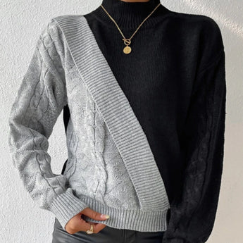 Black ribbed knit turtleneck sweater featuring chunky white contrast sleeves, showcasing a stylish design with focus on the neck and shoulder areas.