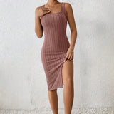 
A black ribbed midi dress with a square neckline and side slit, designed to be form-fitting, displayed on a mannequin.