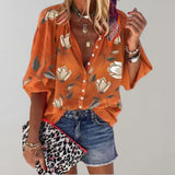 Orange short-sleeve silk blouse with a V-neck design, featuring a floral pattern, suitable for casual summer wear.