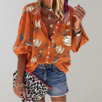 Orange short-sleeve silk blouse with a V-neck design, featuring a floral pattern, suitable for casual summer wear.