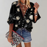 Black silk floral blouse with a V-neck design and short sleeves, suitable for casual summer wear. The blouse is in size 5XL and features a vibrant floral pattern on a black background.