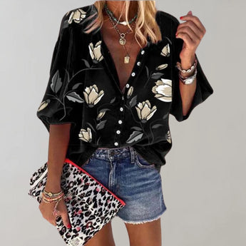 Black silk floral blouse with a V-neck design and short sleeves, suitable for casual summer wear. The blouse is in size 5XL and features a vibrant floral pattern on a black background.