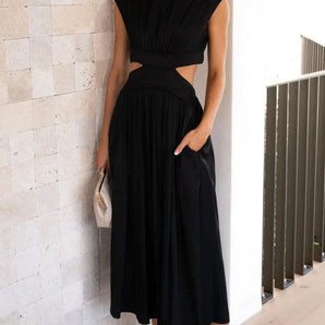 
An elegant black sleeveless cut-out midi dress designed for evening wear, featuring a sophisticated cut that highlights the shoulders and waist. The dress is a one-piece garment with a fitted design, available in Nero color and size XL.
