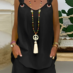 Black sleeveless scoop neck mini dress worn with a boho chic tassel necklace, shown in size XXL.