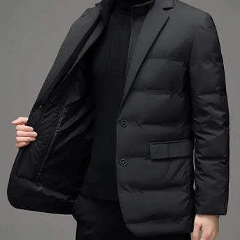 A modern men's formal black slim fit double-breasted blazer displayed on a mannequin, showcasing its structured design with a notch collar, long sleeves, and tailored waistline. The blazer is styled over a grey dress shirt, emphasizing its formal and sleek appearance.