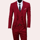 Black slim fit three-piece suit featuring a modern design, suitable for weddings and formal occasions. The suit includes a tailored blazer with a sleek collar and sleeves, complemented by a classic dress shirt underneath. The suit is available in a red color and size 3XL.