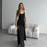 Black sleeveless evening gown with a high slit, showcasing a slim fit design; features a maxi length and elegant silhouette, ideal for formal occasions.