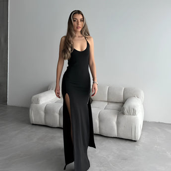 Black sleeveless evening gown with a high slit, showcasing a slim fit design; features a maxi length and elegant silhouette, ideal for formal occasions.