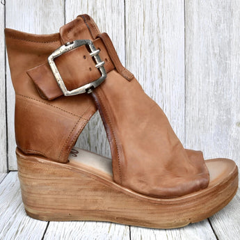 Brown Suede Wedge Sandals with High Platform and Buckle Heel, shown on a human leg, featuring a boho chic design.