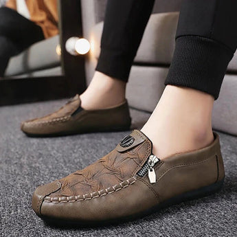 Black textured leather slip-on loafers with a zipper for men, featuring a sleek design in brown and white color combination, size 44.