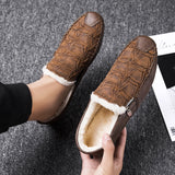 Black textured leather slip-on loafers for men featuring a sleek design with a zipper detail on the side.