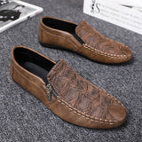 Black textured leather slip-on loafers for men with a decorative zipper, showcasing a sleek and modern design, ideal for a stylish and comfortable dress shoe option.