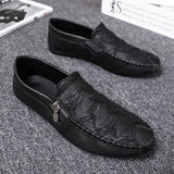 Black textured leather slip-on loafers with a zipper for men, featuring a stylish and sleek design with a smooth finish.