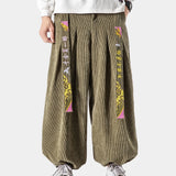 A pair of light green high-waist unisex wide-leg palazzo trousers displayed, featuring a modern design with a loose fit that exudes both style and comfort.