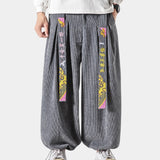 Gray wide-leg palazzo trousers with a high-waist design, suitable for both men and women. The fabric appears to be soft and flexible, ideal for modern fashion.
