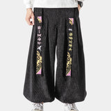 Black wide-leg palazzo trousers with a high waist, designed for a modern and stylish look; suitable for both casual and formal settings.