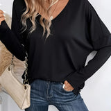Black V-neck long sleeve blouse for women, designed as a casual lightweight top, featuring a comfortable fit at the shoulders and waist, paired with jeans.