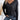 A woman wearing a black V-neck long sleeve blouse, styled casually with jeans. The blouse is lightweight and fits comfortably, perfect for everyday wear.