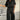 Black V-neck women's jumpsuit, lightweight with drawstring waist, plus size 4XL, modeled by woman.