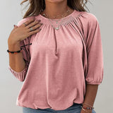
A person wearing a black velvet blouse with a gathered neckline and casual loose fit, in a rose color and size 2XL. The blouse has long sleeves and the person is standing with one arm slightly raised, showcasing the shoulder and neckline details.