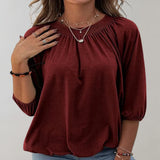 Black velvet blouse with a gathered neckline, shown in Bordeaux color, displayed on a model wearing size 2XL, highlighting the loose fit and long sleeves.
