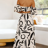 Black and white abstract two-piece dress featuring an off-shoulder top and palazzo pants, showcasing a stylish and chic design.