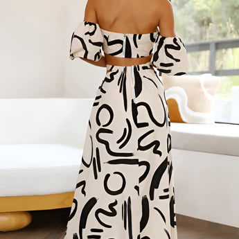 Black and white abstract two-piece dress featuring an off-shoulder top and palazzo pants, showcasing a stylish and chic design.