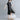 Black and white asymmetric stripe summer midi dress with a loose fit, worn by a person. The dress features a distinct pattern and relaxed style, suitable for warm weather. The individual is accessorized with sunglasses.