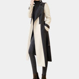 Black and white belted trench coat with a monochrome design, featuring a classic collar and waist tie, modeled by a person wearing sunglasses, a dress shirt, and a tie.