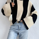 A black and white striped bell sleeve knit sweater worn by a model. The sweater features prominent bell sleeves and falls within the trendy autumn fashion category. The model is showcasing the 3XL variant, highlighting the sweater's fit and style.
