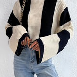 Black and white striped bell sleeve knit sweater featuring a trendy autumn fashion design with distinct sleeve and shoulder details.