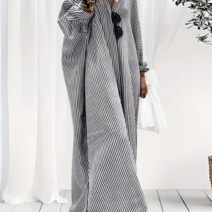 
A plus-size black and white striped maxi dress with long sleeves, designed for breezy beachwear. The dress features a flowing silhouette, a comfortable fit, and is suitable for 3XL size.