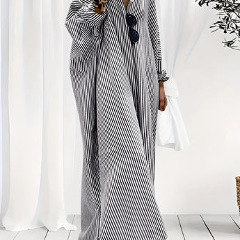 
A plus-size black and white striped maxi dress with long sleeves, designed for breezy beachwear. The dress features a flowing silhouette, a comfortable fit, and is suitable for 3XL size.