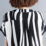 Black and white striped midi dress featuring short sleeves, a button-front design, and a fitted waist.