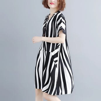 Black and white striped midi dress with short sleeves and a button-front design, featuring a model with styled hair and showing the shoulder and arm details.