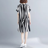 Black and white striped midi dress featuring short sleeves and a button front, displayed on a mannequin.