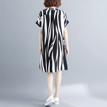 Black and white striped midi dress featuring short sleeves and a button front, displayed on a mannequin.