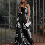 Sleeveless wide-leg jumpsuit featuring a black and white zebra print, displayed on a mannequin; the garment showcases a defined waist and flowing pants.