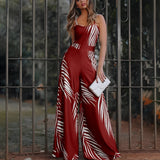 
A sleeveless, wide-leg jumpsuit featuring a black and white zebra print, displayed in a red color variant in size 2XL, with details highlighting the waist and thigh areas.