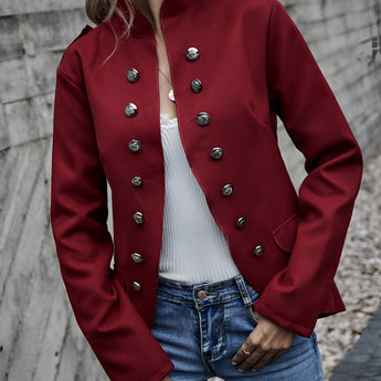 Black women's double-breasted military jacket with silver buttons, featuring stylish autumn fashion, worn by a model standing and paired with jeans and a white dress shirt.