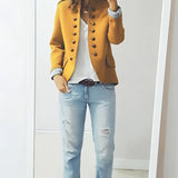 A plus-size yellow double-breasted military jacket with silver buttons, featuring a stylish autumn design, modeled by a woman.