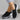 Black women's lightweight breathable slip-on sneakers with a focus on comfort and ease of wear, displayed in a minimalist setting.