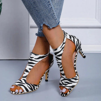 
A pair of black women's slingback stiletto peep-toe heels, designed as formal sandals with a zebra pattern, shown in size 43.