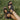 Black women's strappy open-toe wedge sandals on a model's foot standing on grass, showcasing the comfortable and durable design.