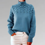 
A blue wool cable knit turtleneck sweater for women, featuring a cozy design suitable for fall fashion in size 2XL.