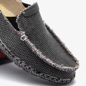 Black woven loafers, breathable and lightweight slip-on shoes with a textured pattern.