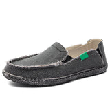 Lightweight black woven loafers in a slip-on style, featuring a breathable design and a subtle pattern. The shoes are showcased in a gray color variant and are size 12, suitable for outdoor walking and casual settings.