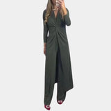Green wrap V-neck midi dress with asymmetrical design featuring long sleeves and a fitted waist, worn by a model.